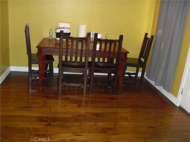 dining space featuring dark hardwood / wood-style flooring