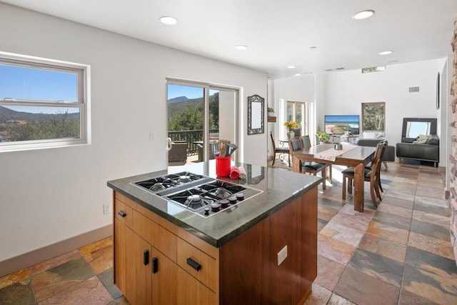 kitchen with a kitchen island and stainless steel gas cooktop