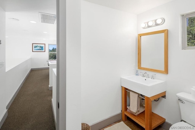 bathroom featuring a bath and toilet