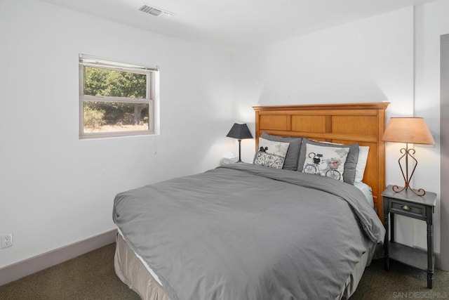 bedroom featuring dark carpet