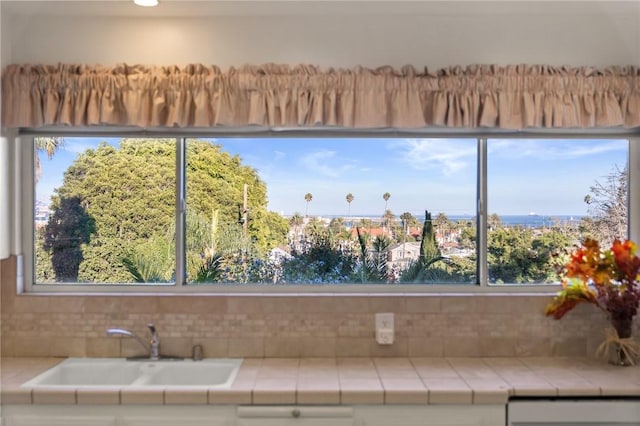 661 W 26th St, San Pedro, CA 90731 - kitchen featuring tile counters, a sink, dishwasher, and backsplash