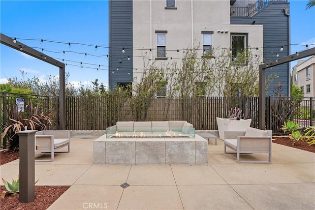 view of patio / terrace with an outdoor living space with a fire pit