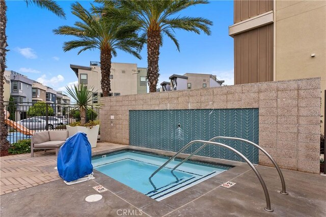 view of pool featuring a hot tub