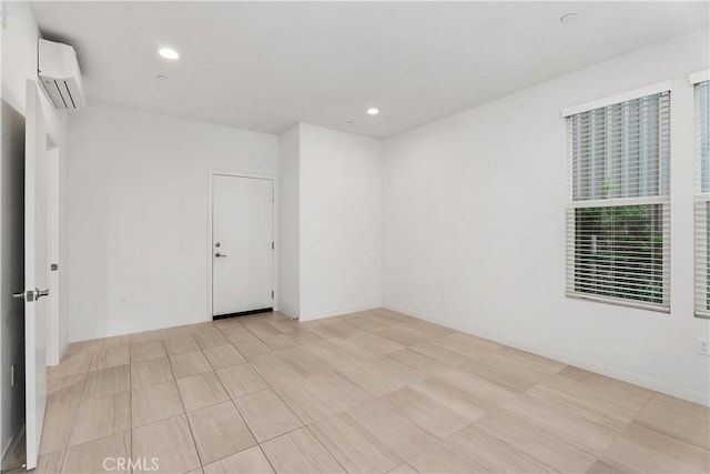 spare room with a wall mounted air conditioner