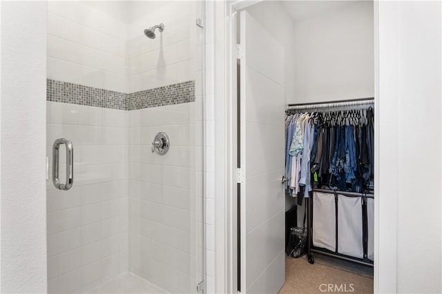 bathroom featuring a shower with shower door