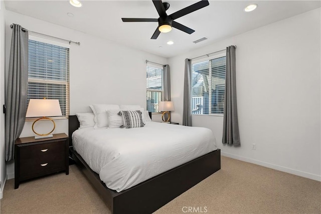 bedroom featuring light colored carpet and ceiling fan