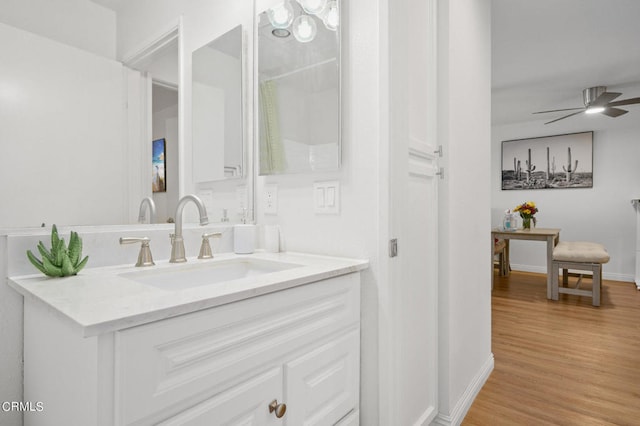 bathroom featuring ceiling fan, hardwood / wood-style flooring, and vanity