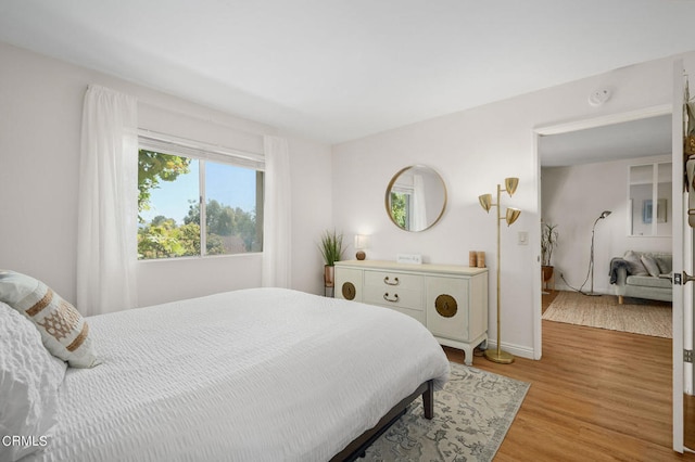 bedroom with hardwood / wood-style flooring