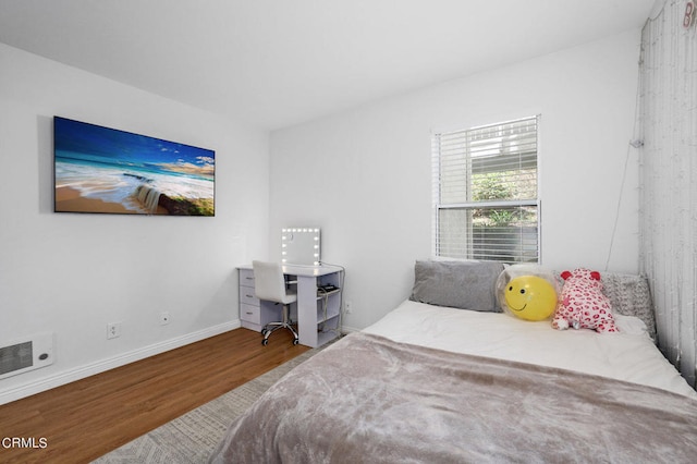 bedroom with hardwood / wood-style floors