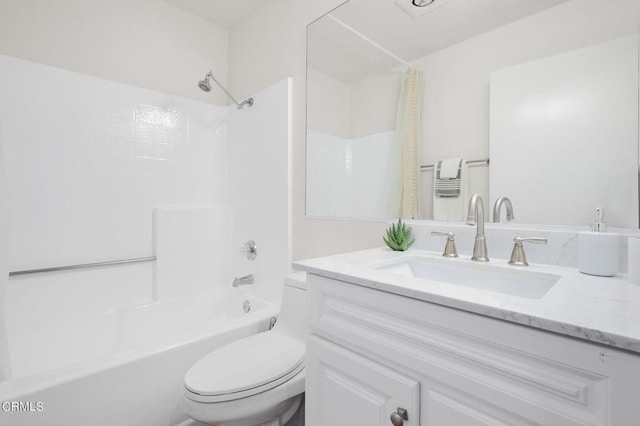 full bathroom featuring vanity, shower / bath combo with shower curtain, and toilet