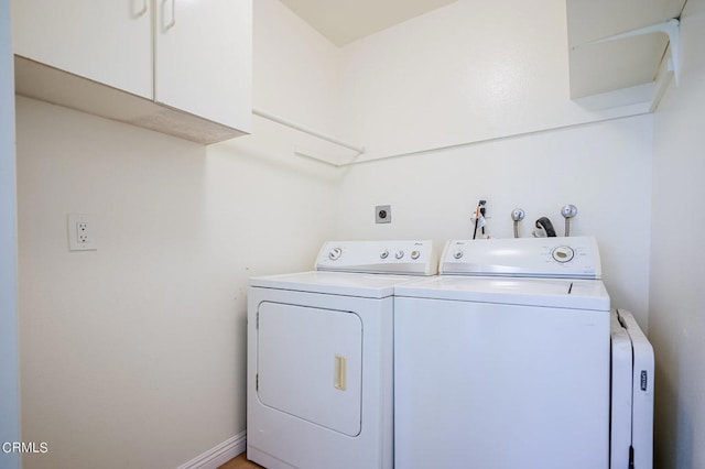 laundry room featuring cabinets and independent washer and dryer