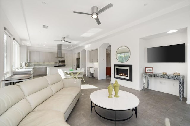 tiled living room with sink and ceiling fan