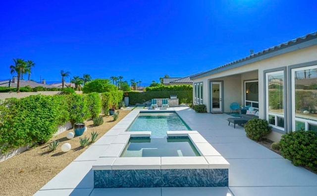 view of swimming pool with a patio and an in ground hot tub