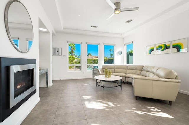 tiled living room with ceiling fan