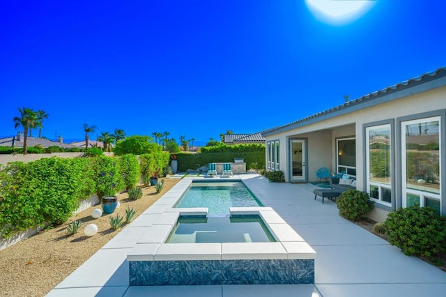 view of pool with a patio and an in ground hot tub