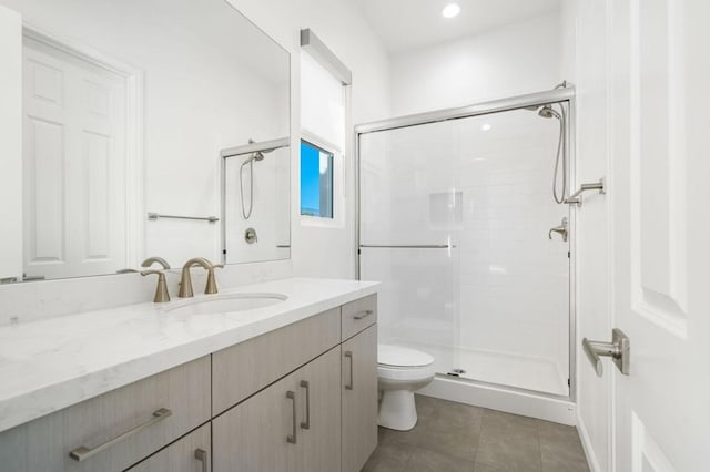 bathroom featuring tile patterned flooring, an enclosed shower, vanity, and toilet