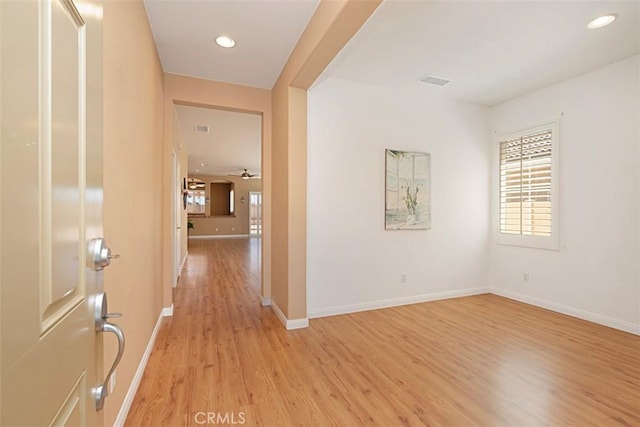 corridor with light hardwood / wood-style floors