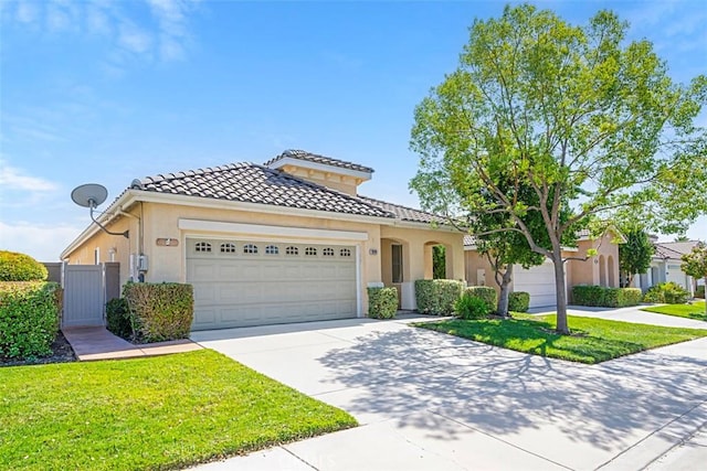 mediterranean / spanish-style house with a front lawn and a garage