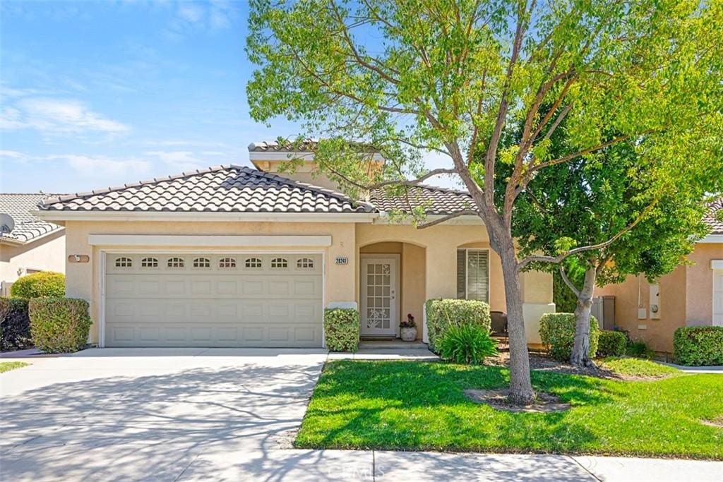 28241 Glenside Ct, Menifee, CA 92584 - mediterranean / spanish-style house featuring a garage and a front yard