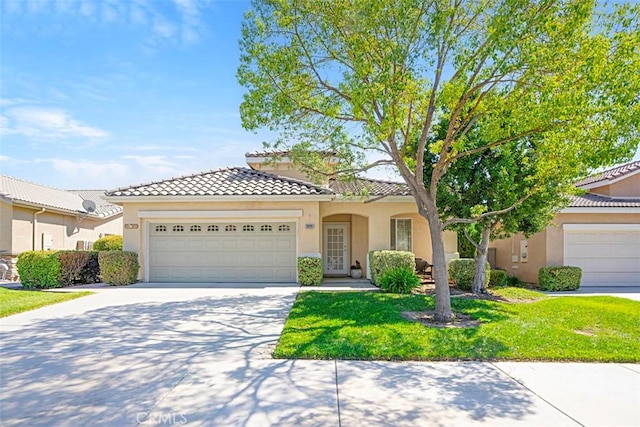 view of front of home featuring a garage and a front yard