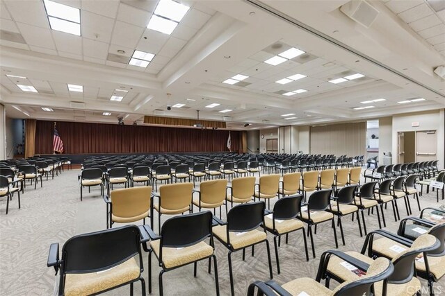 misc room with a paneled ceiling and light colored carpet