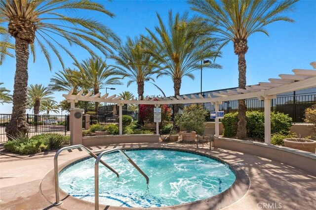 view of swimming pool featuring a pergola and a hot tub