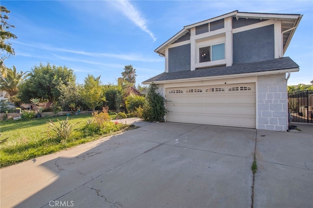 view of front facade with a front yard and a garage