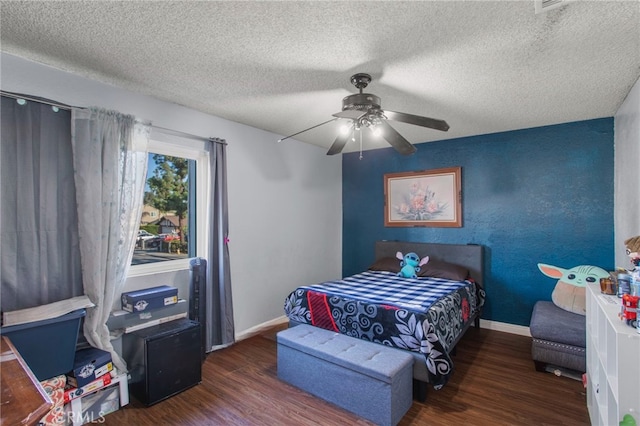 bedroom featuring ceiling fan, a textured ceiling, and dark wood-type flooring