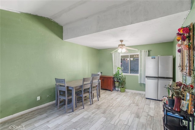 dining area featuring light hardwood / wood-style floors and ceiling fan