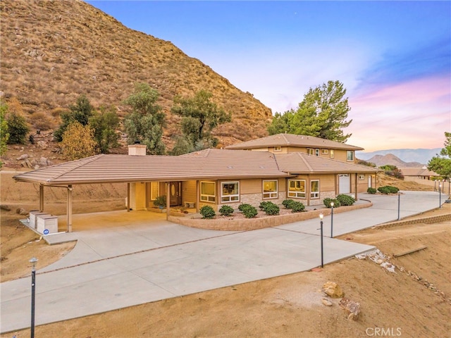 view of front of property featuring a mountain view, a carport, and a garage