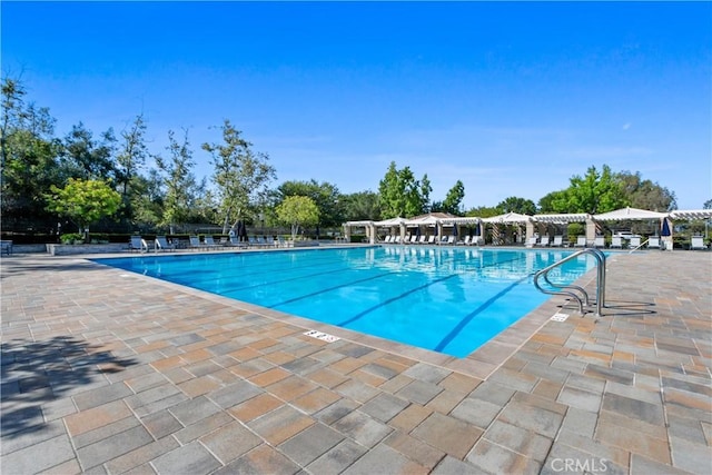 view of swimming pool with a pergola and a patio area