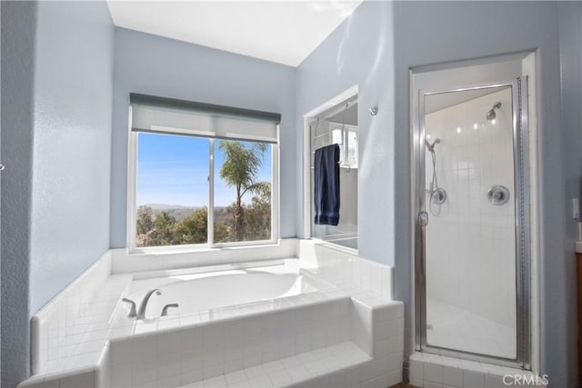 bathroom with shower with separate bathtub