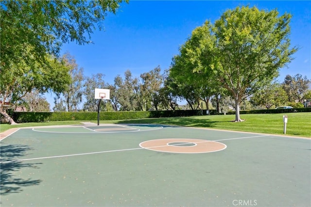 view of sport court with a yard