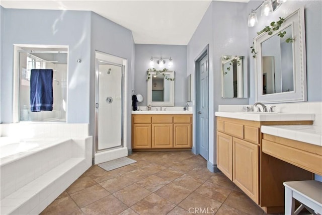 bathroom with vanity and shower with separate bathtub