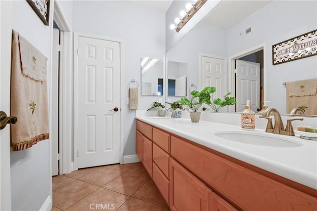 bathroom with tile patterned floors and vanity