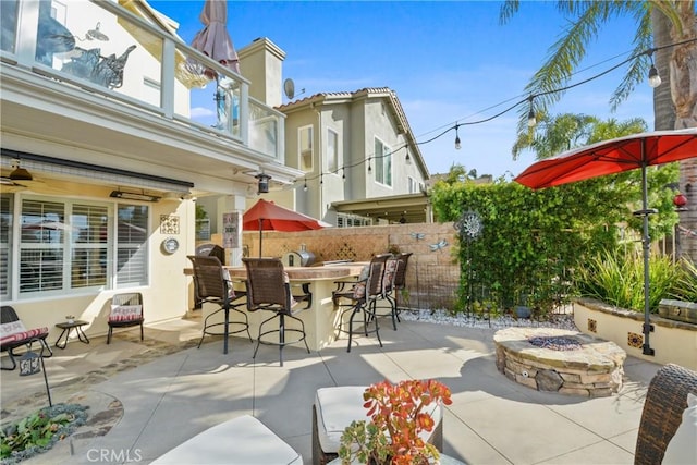 view of patio / terrace featuring a fire pit and a bar