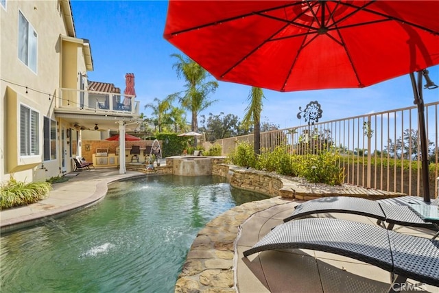 view of pool with an in ground hot tub, pool water feature, and a patio