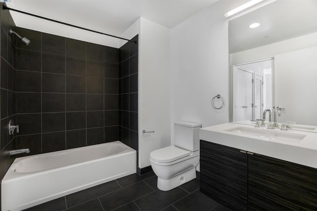 full bathroom featuring tile patterned flooring, tiled shower / bath combo, toilet, and vanity