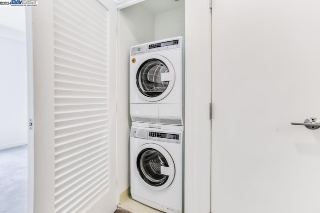 washroom featuring stacked washer and clothes dryer