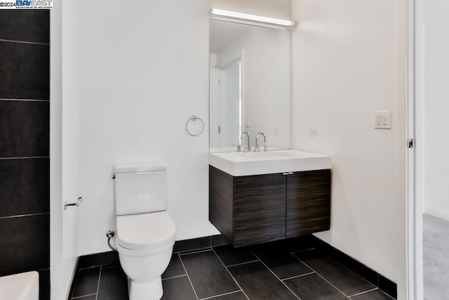 bathroom featuring tile patterned flooring, vanity, and toilet