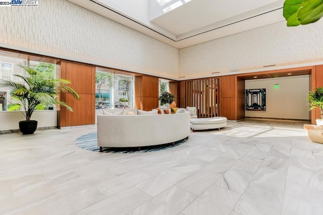 living room featuring a towering ceiling