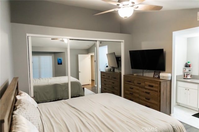 bedroom featuring ceiling fan, a closet, and light wood-type flooring