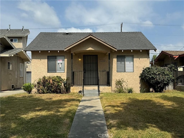 bungalow-style house with a front lawn