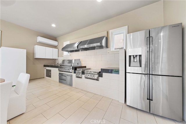 kitchen with stainless steel fridge with ice dispenser, white cabinetry, a wall mounted AC, and exhaust hood