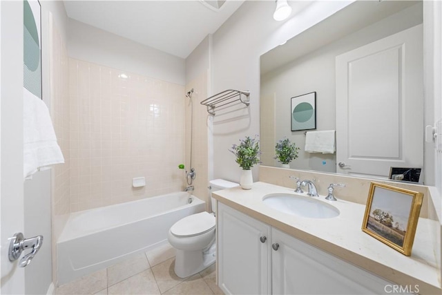 full bathroom with tile patterned flooring, vanity, tiled shower / bath combo, and toilet