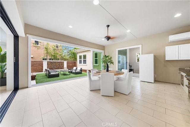 unfurnished sunroom featuring ceiling fan