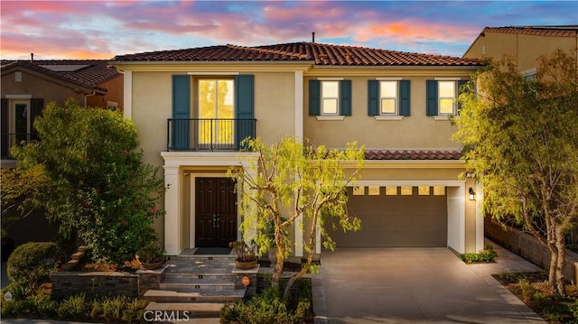 mediterranean / spanish house featuring a garage