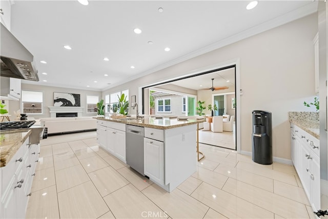 kitchen with dishwasher, light stone counters, an island with sink, a breakfast bar area, and white cabinets