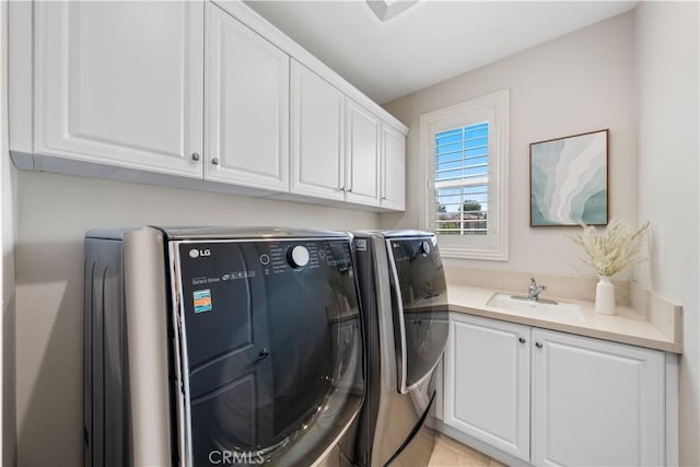 laundry room featuring cabinets, sink, and washing machine and clothes dryer