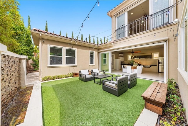 rear view of property with outdoor lounge area, a patio area, a balcony, and a yard